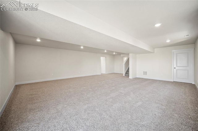 finished basement featuring recessed lighting, carpet flooring, stairway, and baseboards