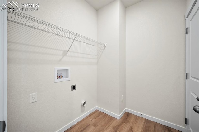 laundry room featuring hookup for a washing machine, electric dryer hookup, wood finished floors, laundry area, and baseboards