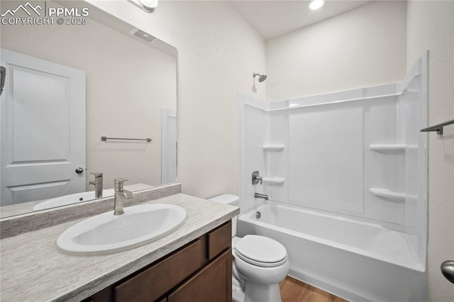 full bath with visible vents, toilet, wood finished floors, bathtub / shower combination, and vanity