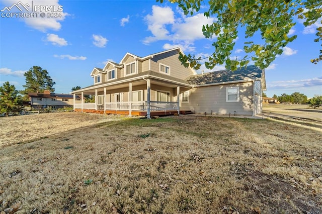 view of front of house with a front yard and a porch