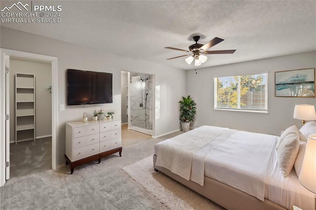 6555 Turkey Tracks Rd, Colorado Springs, CO 80922 - bedroom featuring a walk in closet, light carpet, baseboards, and ceiling fan