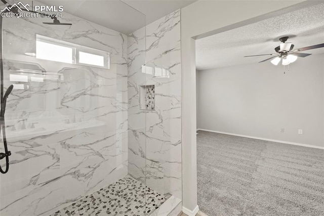 bathroom with a tile shower and ceiling fan