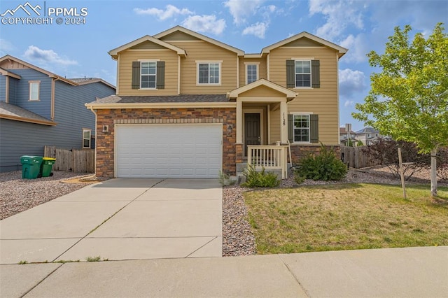 view of front of property featuring a front yard and a garage