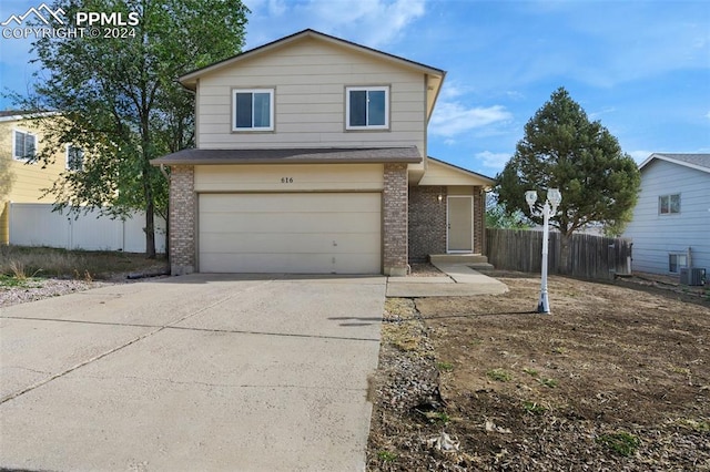 view of property with a garage and central AC unit