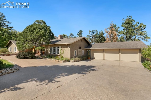 ranch-style home featuring a garage