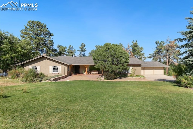 single story home featuring a garage and a front lawn