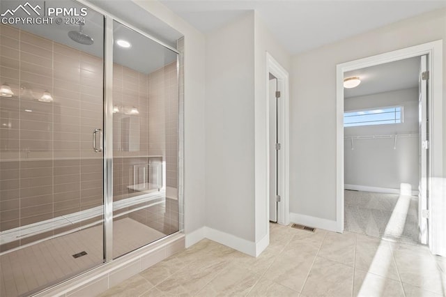 bathroom featuring a shower with door and tile patterned flooring