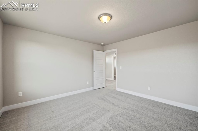 unfurnished room with light carpet