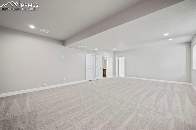 unfurnished room with light colored carpet