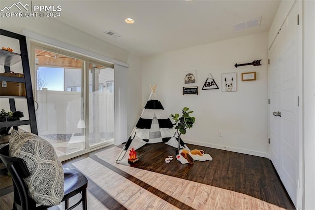 sitting room with dark hardwood / wood-style flooring