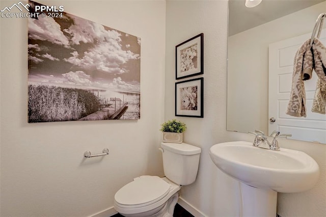 bathroom with toilet and sink