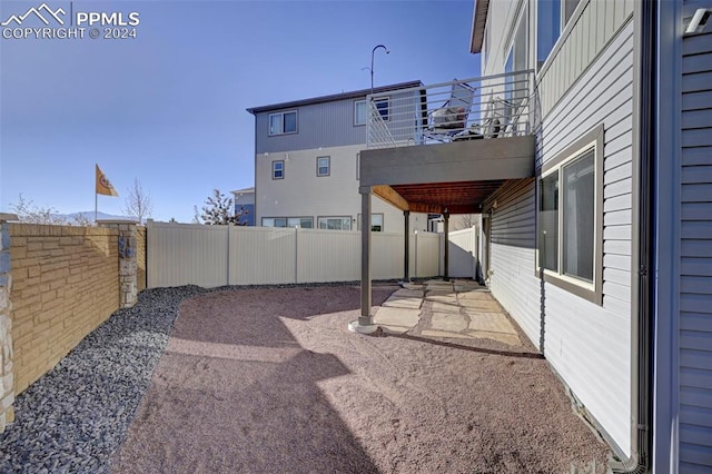 view of yard with a patio area and a balcony