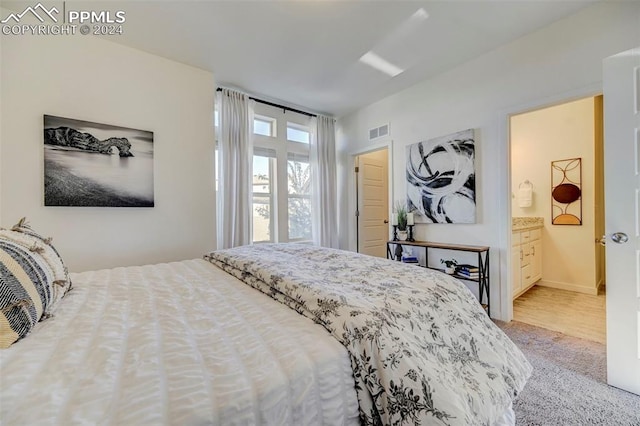 carpeted bedroom with ensuite bathroom