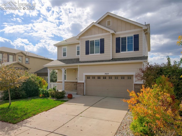 craftsman inspired home with a front yard and a garage