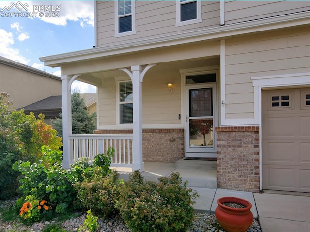 entrance to property with a porch and a garage