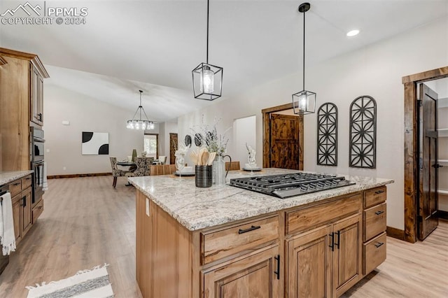 kitchen featuring a kitchen island, decorative light fixtures, stainless steel appliances, light wood-type flooring, and vaulted ceiling