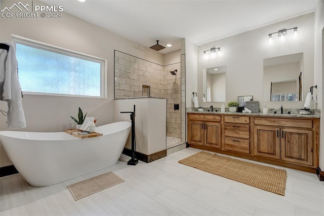 bathroom featuring tile patterned floors, vanity, and independent shower and bath