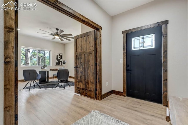 foyer with light wood-type flooring and ceiling fan