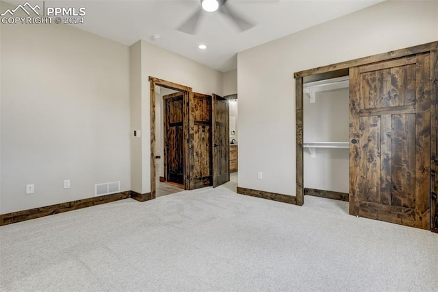 unfurnished bedroom with ceiling fan, a closet, and carpet flooring