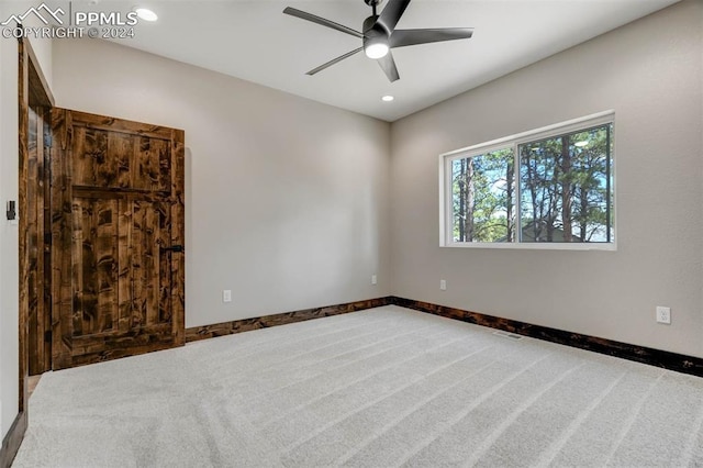 empty room with ceiling fan and carpet