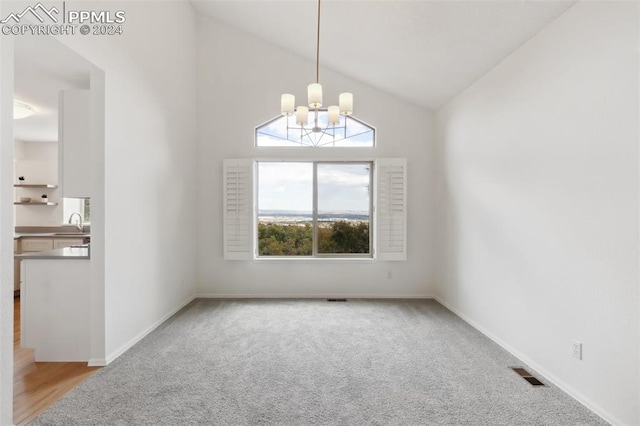 interior space with sink, a chandelier, light colored carpet, and high vaulted ceiling