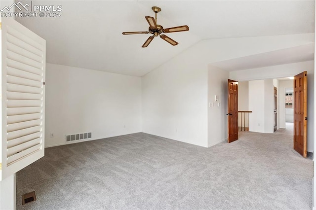 spare room featuring ceiling fan, carpet flooring, and lofted ceiling