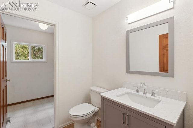 bathroom featuring vanity and toilet