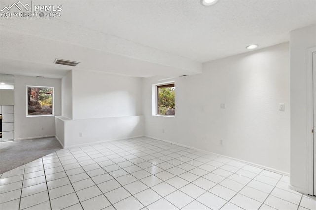 tiled empty room featuring a wealth of natural light