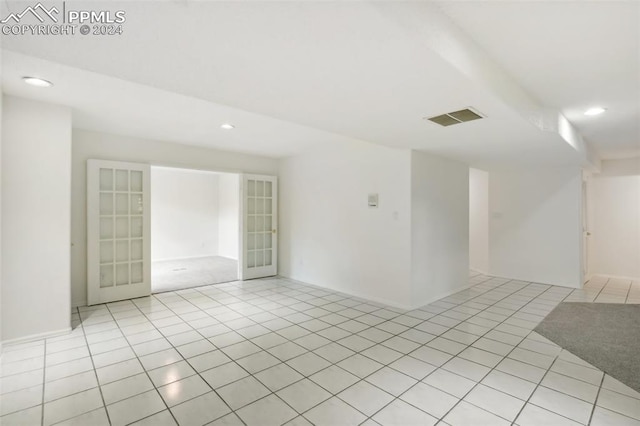 tiled empty room with french doors