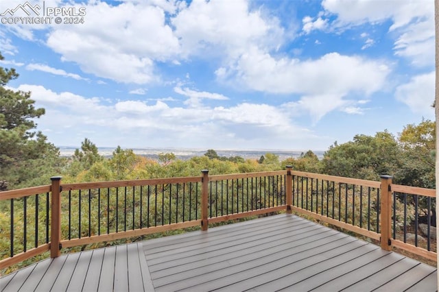 wooden terrace featuring a water view