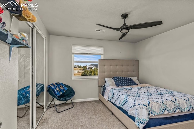 bedroom with carpet floors, baseboards, visible vents, and ceiling fan