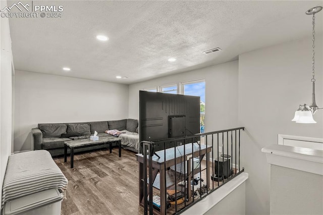 living room featuring hardwood / wood-style floors and a textured ceiling