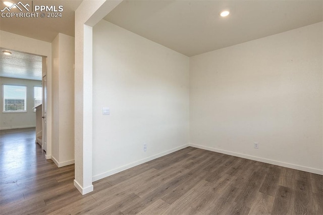 spare room with dark hardwood / wood-style flooring