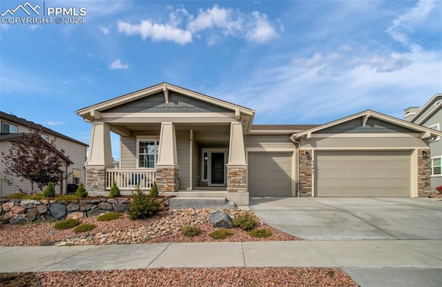 craftsman house featuring covered porch and a garage