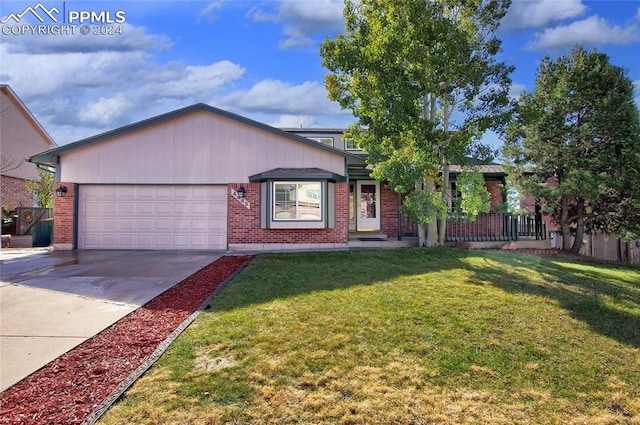 ranch-style house featuring a front lawn and a garage