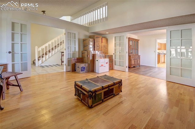 living room with light hardwood / wood-style floors and french doors