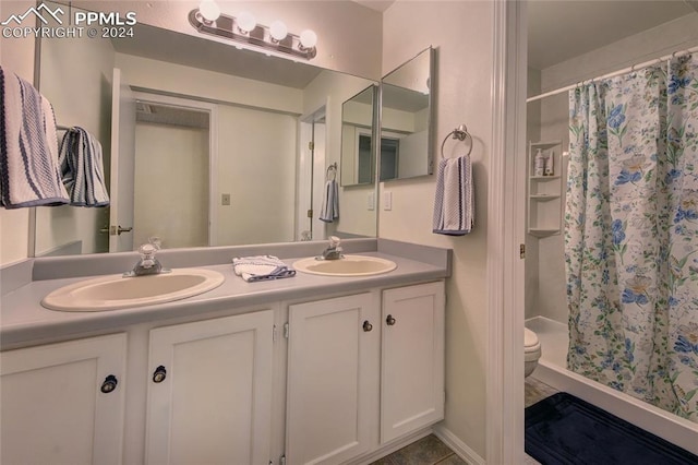 bathroom with toilet, walk in shower, and vanity