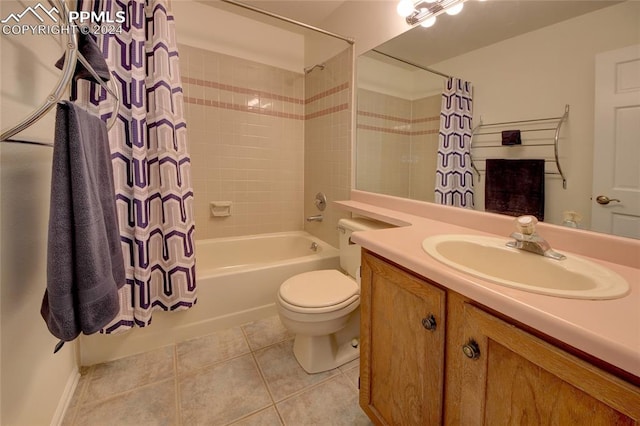 full bathroom featuring toilet, vanity, tile patterned floors, and shower / tub combo