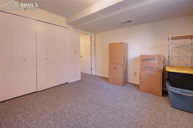 unfurnished bedroom with a closet, carpet flooring, and a textured ceiling