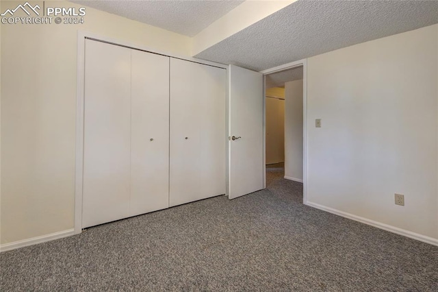 unfurnished bedroom with a closet, a textured ceiling, and carpet floors