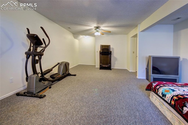 carpeted bedroom with a textured ceiling and ceiling fan