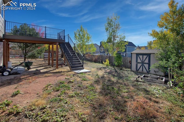 view of yard with a wooden deck and a storage unit