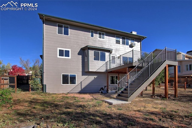 rear view of house featuring a deck