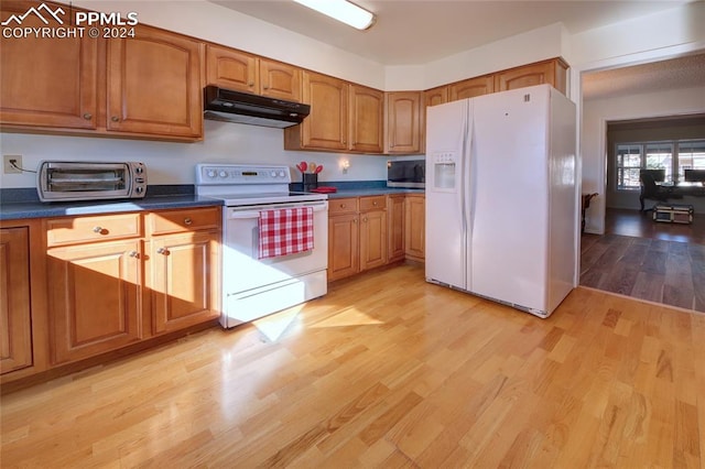 kitchen featuring light hardwood / wood-style floors and white appliances