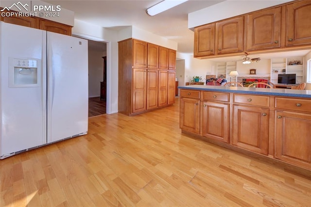 kitchen featuring white fridge with ice dispenser, light hardwood / wood-style flooring, and ceiling fan