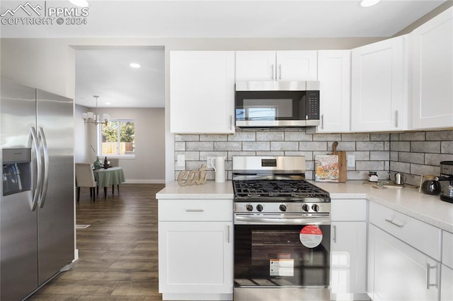 kitchen featuring dark hardwood / wood-style flooring, an inviting chandelier, white cabinets, and appliances with stainless steel finishes