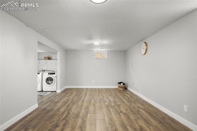 washroom with wood-type flooring, a textured ceiling, and washing machine and clothes dryer