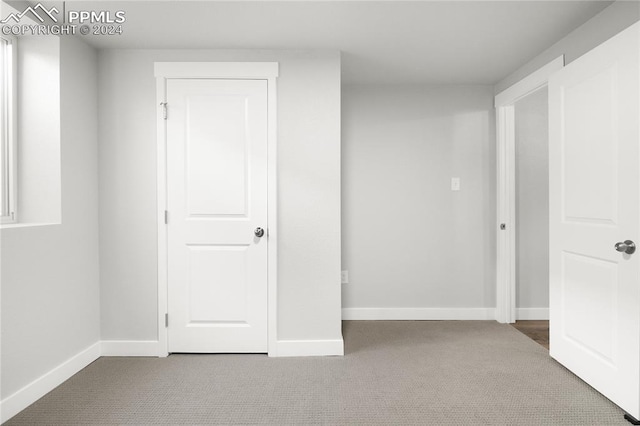 unfurnished bedroom with light colored carpet