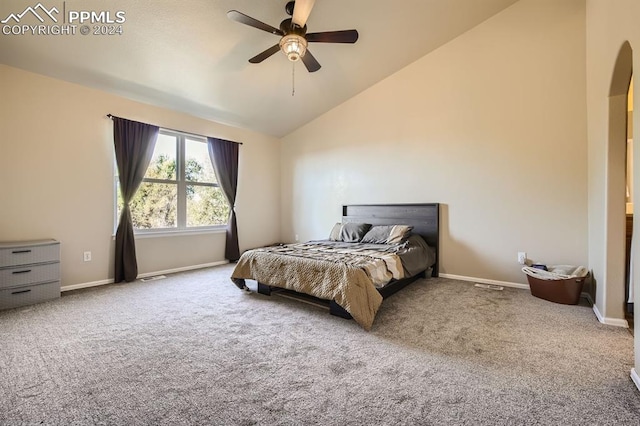 carpeted bedroom featuring high vaulted ceiling and ceiling fan