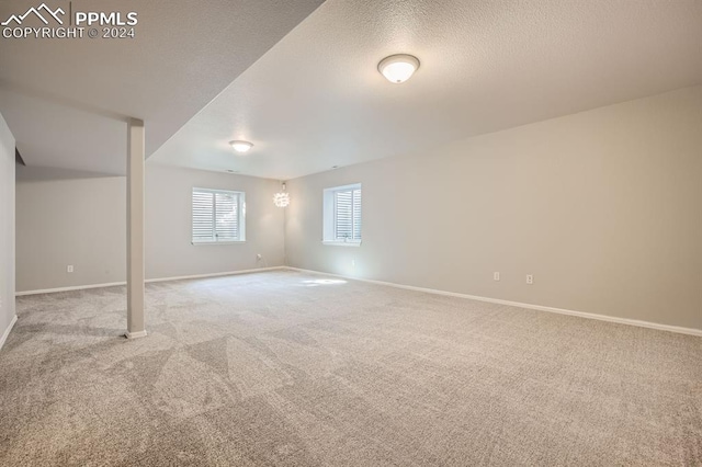 basement with light carpet and a textured ceiling